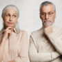 Portrait of thoughtful mature bearded male and his wife look pensively, being deep in thoughts, think about their life and achievements, isolated on white background. People, age and wisdom concept